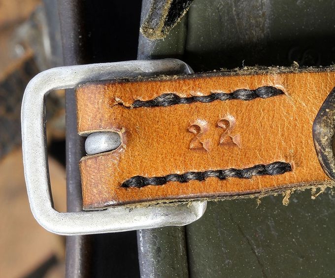 Reverse side of a chinstrap short end with aluminum buckle on an M35. Notice the number 22 and the parallel seams. This type of stitching is different from that shown in the picture above. 